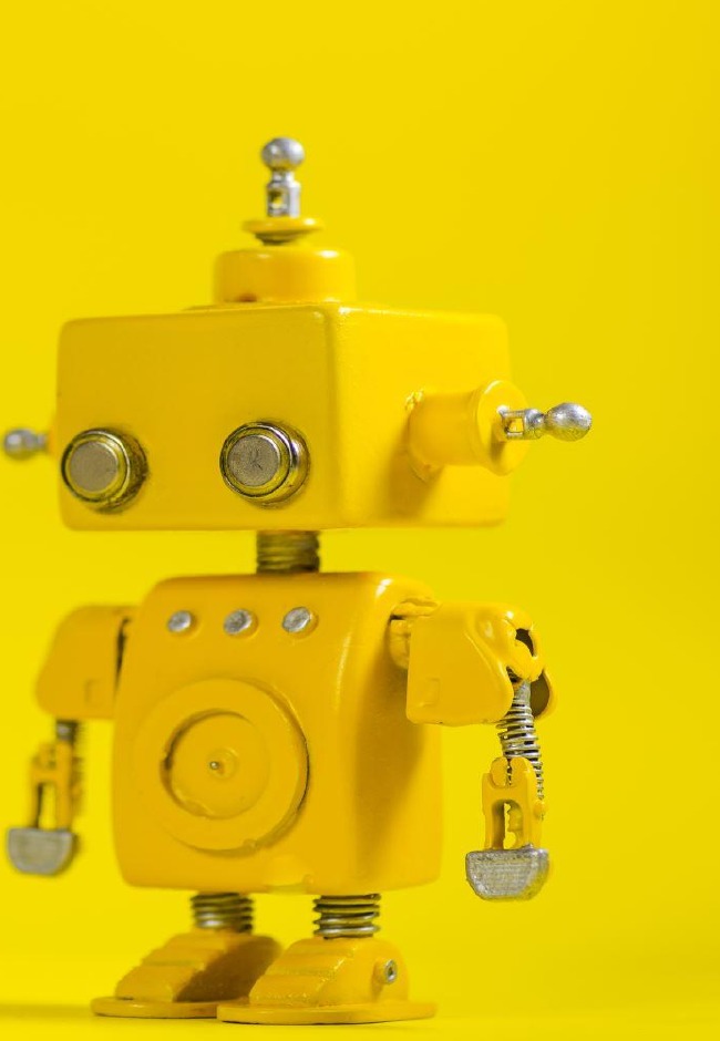 Yellow humanoid robot looking toward the viewer